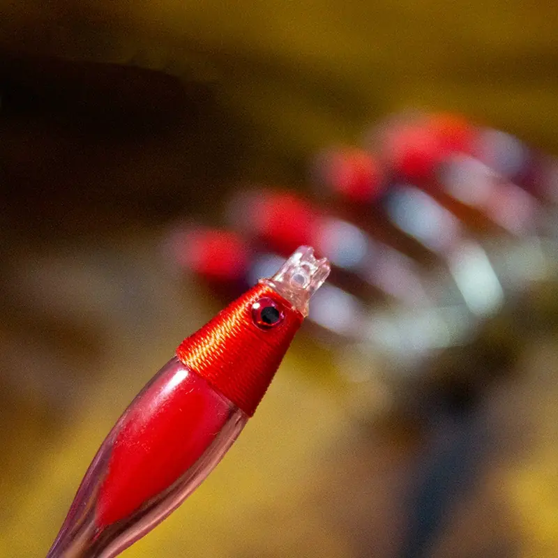 Red head mini transparent shrimp squid jig detail showing 3D bionic eye, cloth wrap and connection ring