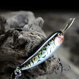 Sinking minnow lure with metal lip resting on natural wood background showing sharp treble hook